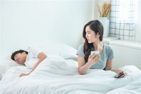 Premium Photo Wife Spying The Phone Of Her Husband While Man Sleeping