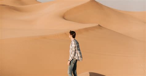 Photo Of Man Standing On Desert · Free Stock Photo