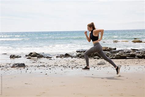 Woman Running On The Beach By Stocksy Contributor Curtis Kim Stocksy