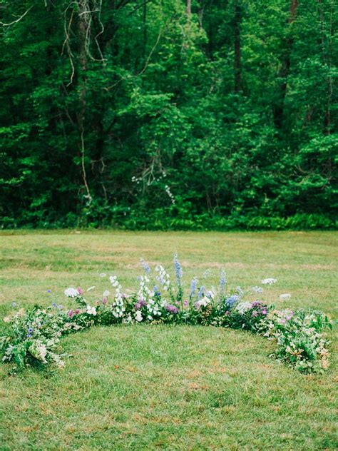 A Wedding Ceremony Trend Were Loving Grounded Floral Arches Wedding