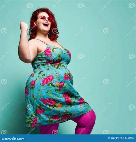 Happy Plus Size Lady Overweight Woman In Fashion Sunglasses And Colorful Clothes Shows Yes Sign
