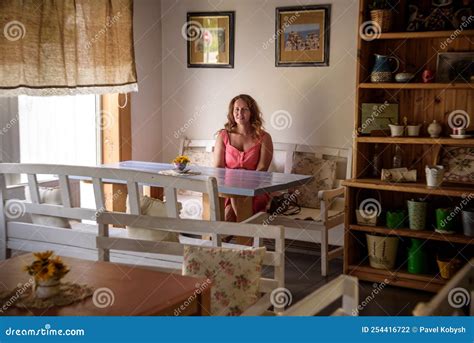 Enthusiastic Woman in Trendy Summer Outfit Chilling in Cozy Cafe