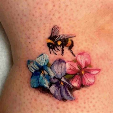 A Womans Stomach With Flowers And A Bee On It