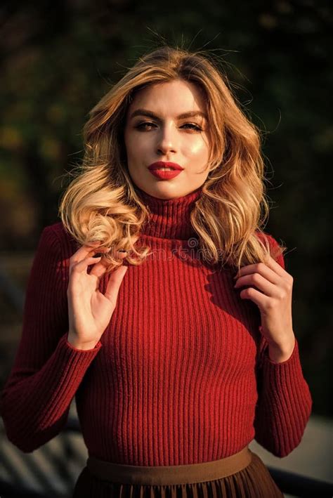 Girl Long Blond Hair Girl Red Lipstick In Knitwear Sweater Cosmetics And Skin Care Trend Stock