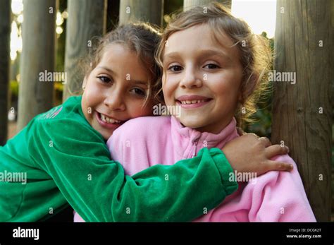 Portrait Of Two Girls Embracing Outdoors Stock Photo Alamy