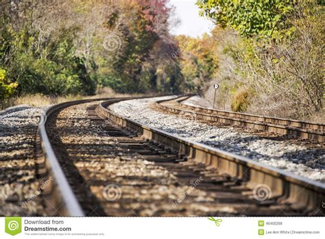 Train Tracks Disappearing Into A Rural Autumn Landscape