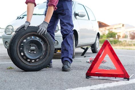 Man Changing A Flat Tire On The Side Of The Road Stock Photo Image Of Accident Service