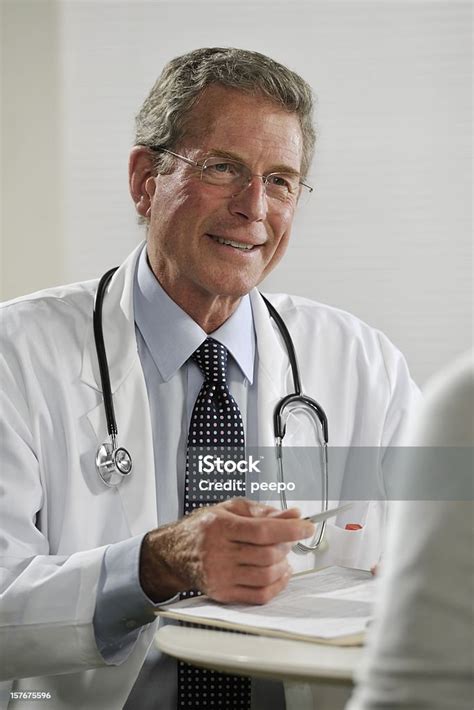 Senior Male Doctor Treating Patient Stock Photo Download Image Now