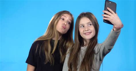 Girls Taking Selfie Smiling Posing Looking At Photos On Smartphone