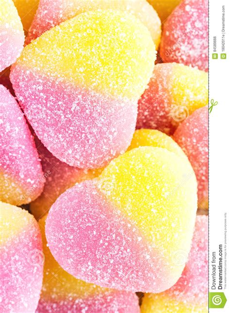 Background Of Yellow And Pink Fruit Candy In Shape Of Heart Close Up