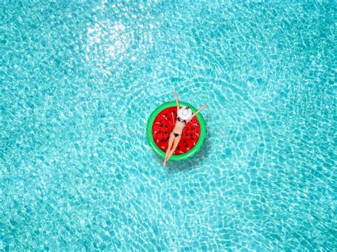 Beautiful Woman In A Bikini Enjoys The Tropical Sun On A Watermelon