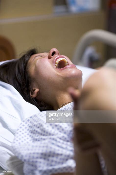 High Angle View Of A Female Patient Showing Uncomfortable Expression