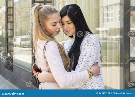 Two Women Hugging On A City Street Stock Image Image Of Blonde Closed