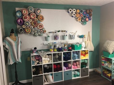 This craft room makeover post shares great organization ideas and tips for scrapbooking, paper and ribbon storage while still decorating on a budget. Make Your Own Easy Hanging Yarn Wall Decor Decor by ...