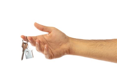 흰색 배경 클리핑 패스에 격리된 집 열쇠를 들고 있는 손 프리미엄 사진