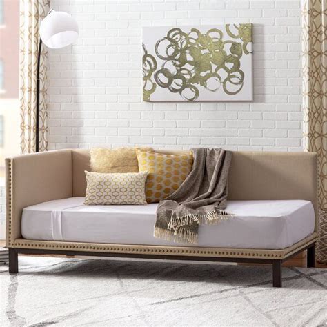 A Living Room With A White Brick Wall And Beige Furniture In The Corner