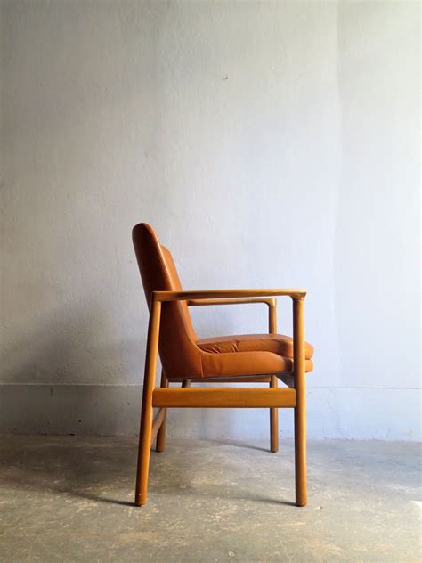 Upholstered with a durable cognac faux leather. Vintage cognac leather armchair - Design Market