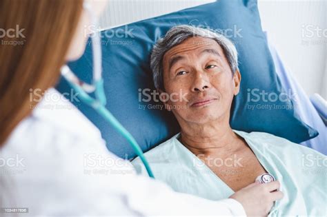Close Up Doctor Hand Examining Old Asian Patient By Using Stethoscope