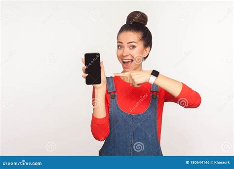 Look At Awesome Mobile Device Portrait Of Amazed Pretty Girl Pointing At Cellphone And Looking