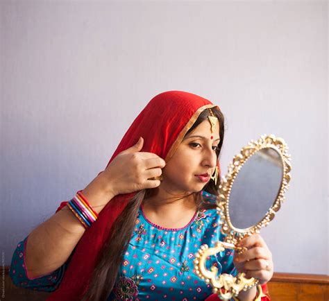 Young Indian Woman With Traditional Dress And Ornaments And Looking At