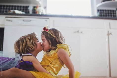 Two Preschool Aged Sisters Kissing In Princess Dresses By Rob And Julia