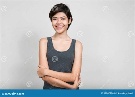 Portrait Of Happy Young Beautiful Teenage Girl Smiling With Arms
