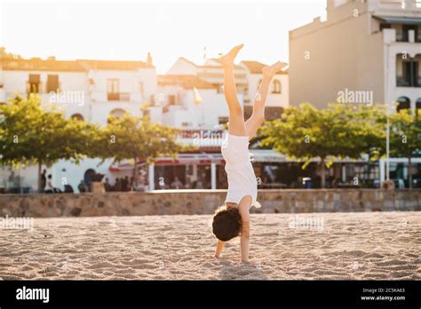 Little Girl Doing A Handstand On The Beach Stock Photo Alamy