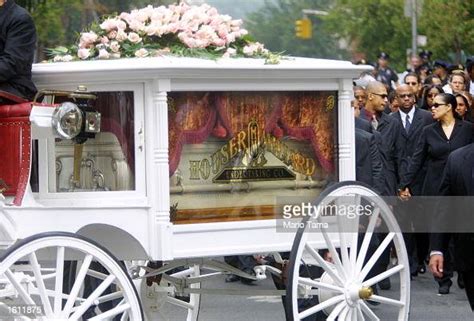 A Horse Drawn Carriage Carries Randb Singer Aaliyahs Coffin Towards
