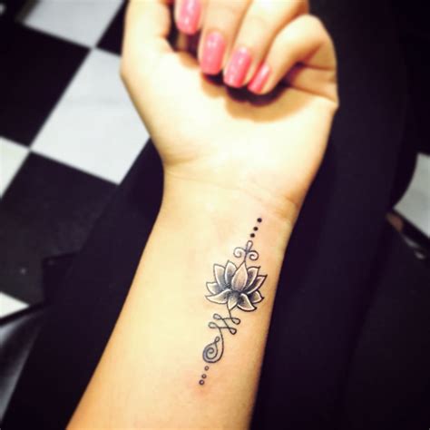 small wrist lotus flower tattoo