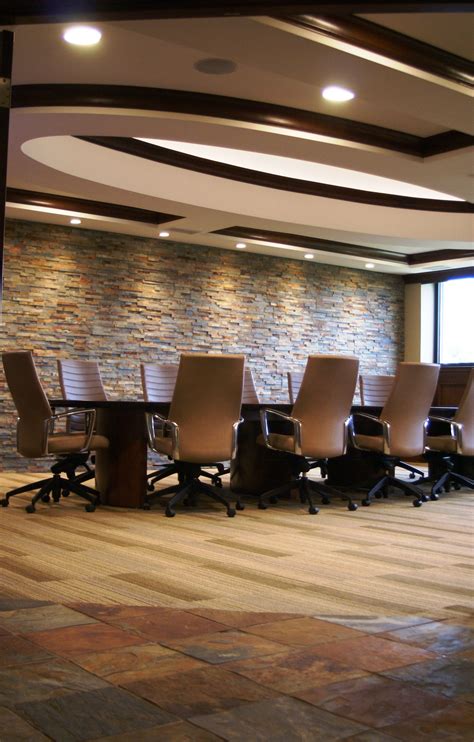 A Conference Room With A Stone Wall To Accent The Decor Beautiful