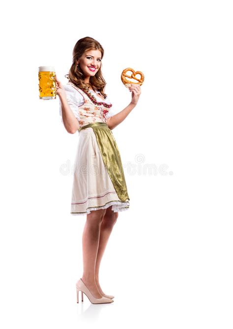 Woman In Traditional Bavarian Dress Holding Beer And Pretzel Stock