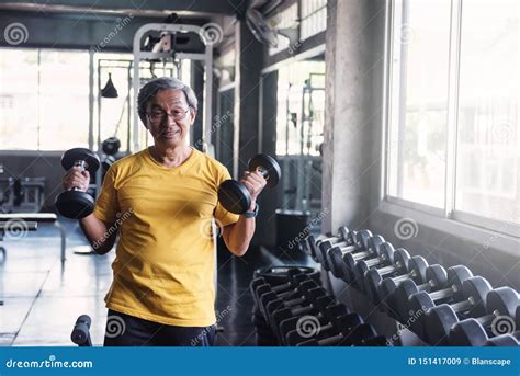 Senior Strong Man Dumbbell Exercise In Gym Stock Image Image Of
