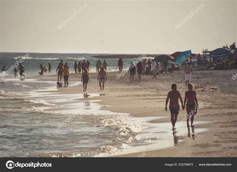 People Walking Beach Stock Editorial Photo © Yayimages 323769972