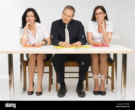Three People Sitting At Desk Stock Photo Alamy