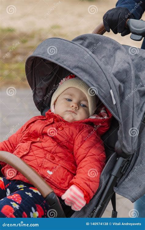 The Little Baby Is Sitting In The Pram Stock Photo Image Of Face
