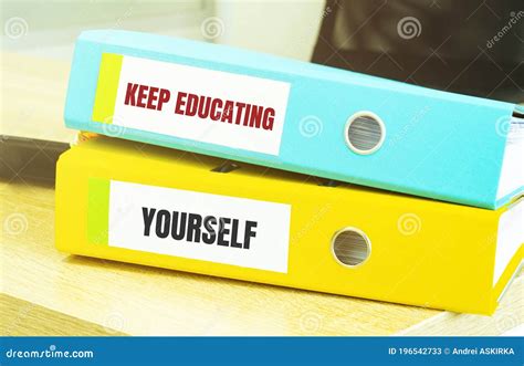 Two Office Folders With Text Keep Educating Yourself Stock Image