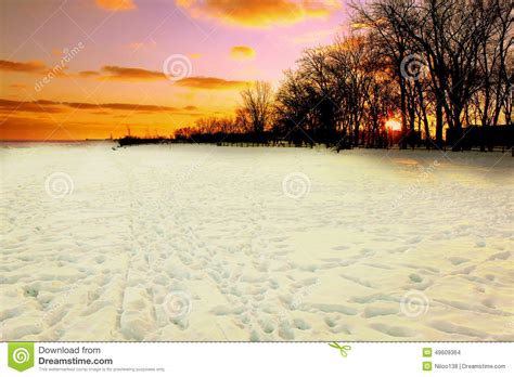 Winter Sunset Over Snow Covered Beach Stock Photo Image