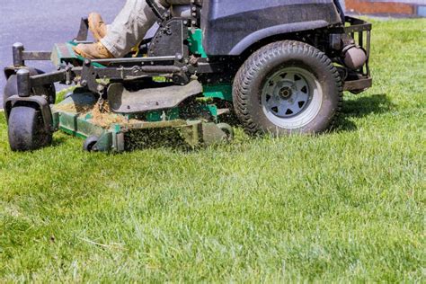 Machine For Cutting Lawns On Lawn Mower On Green Grass In Garden Stock