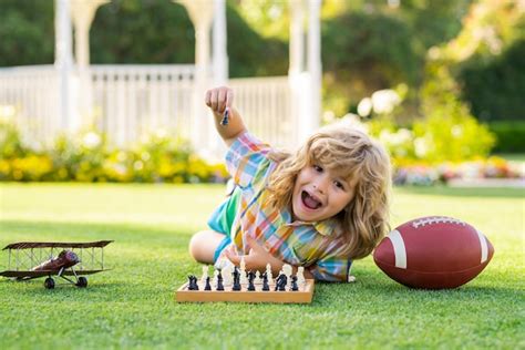 Premium Photo Little Kid Play Chess In Park Child Boy Playing Board