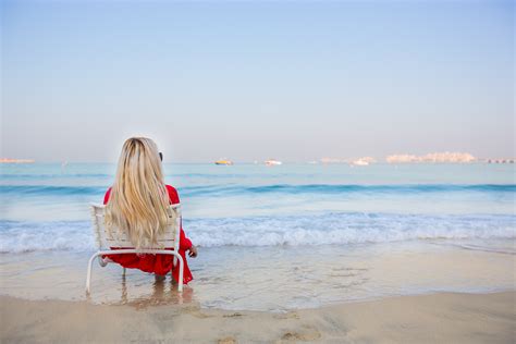 blonde women sitting long hair women outdoors model beach sea chair women on beach sky
