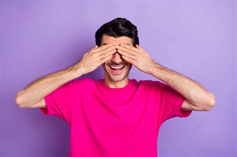 Photo Of Funny Playful Young Man Wear Pink Tshirt Arms Cover Eyes