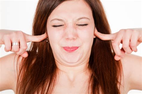Young Woman Closing Her Ears With Fingers Stock Photo Download Image
