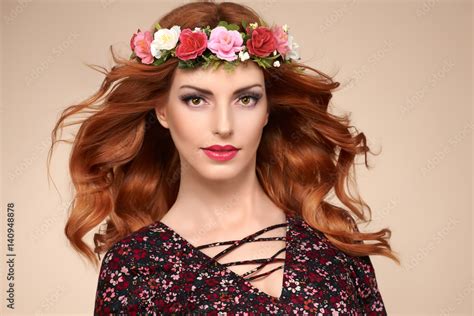 beautiful curly redhead portrait in fashion flower wreath shiny curly flower volume hairstyle