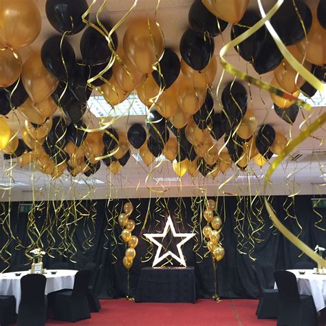 Black And Gold Balloon Ceiling Decoration With Gold Light Up Star