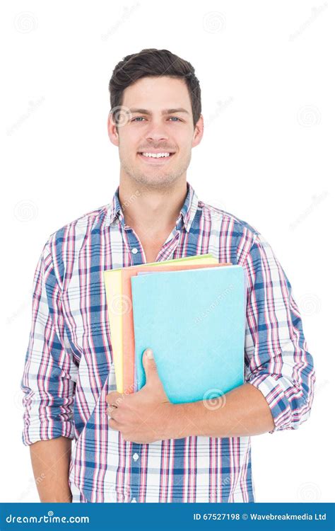 Portrait Of Smiling Male College Student Holding Books Stock Photo