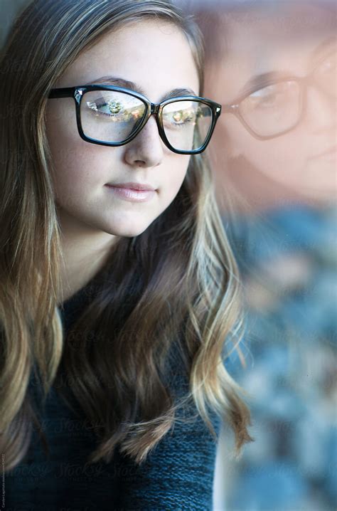 Teen Girl With Long Hair And Glasses Looking Out The Window By Carolyn
