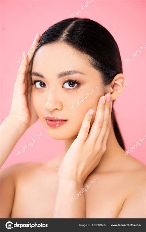 Naked Asian Woman Touching Face While Looking Camera Isolated Pink