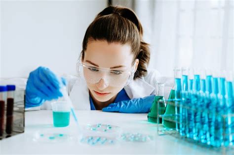 Female Scientist Researcher Conducting An Experiment In A Laboratory