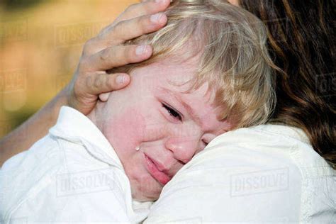 A Young Boy Crying On His Mothers Shoulder Edmonton Alberta Canada