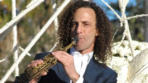 A Man In A Suit Playing A Saxophone With The Words Kenny G Super G